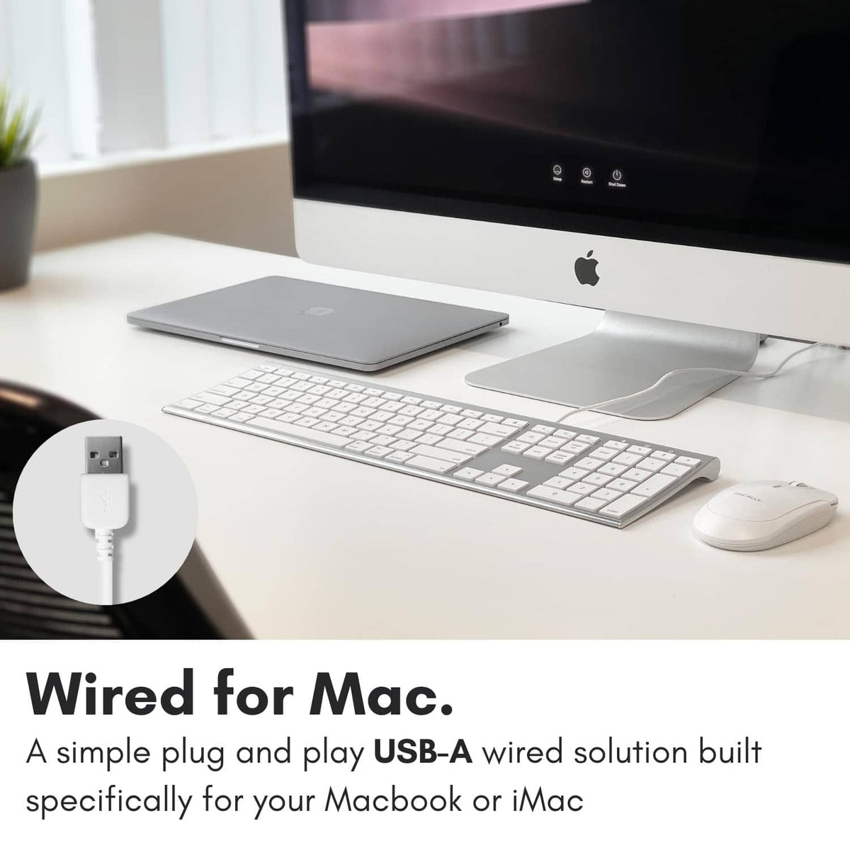 Silver wired full-size keyboard with white keycaps and attached USB cable