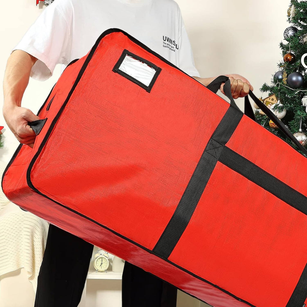 Red Christmas tree storage bag with black straps, carried by a person