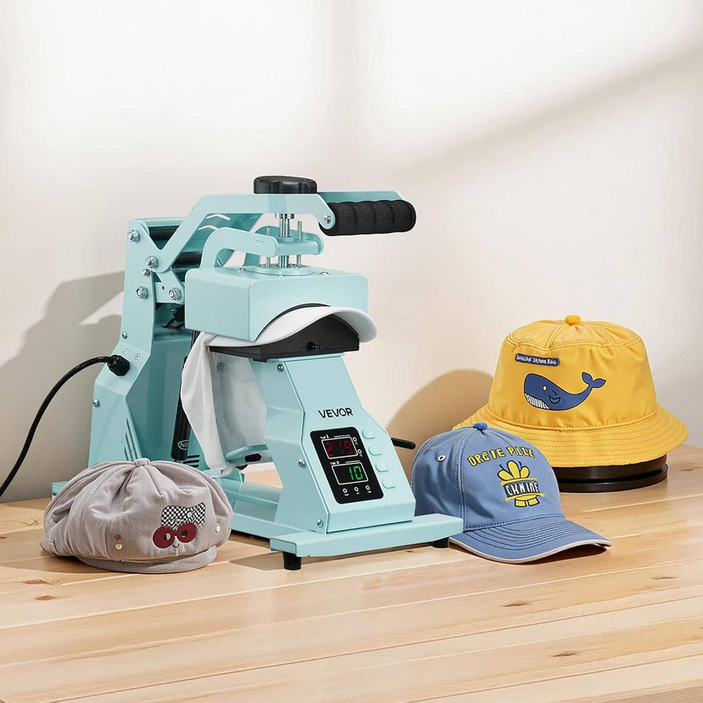 Teal hat heat press machine with digital panel and front platen, with three caps on table