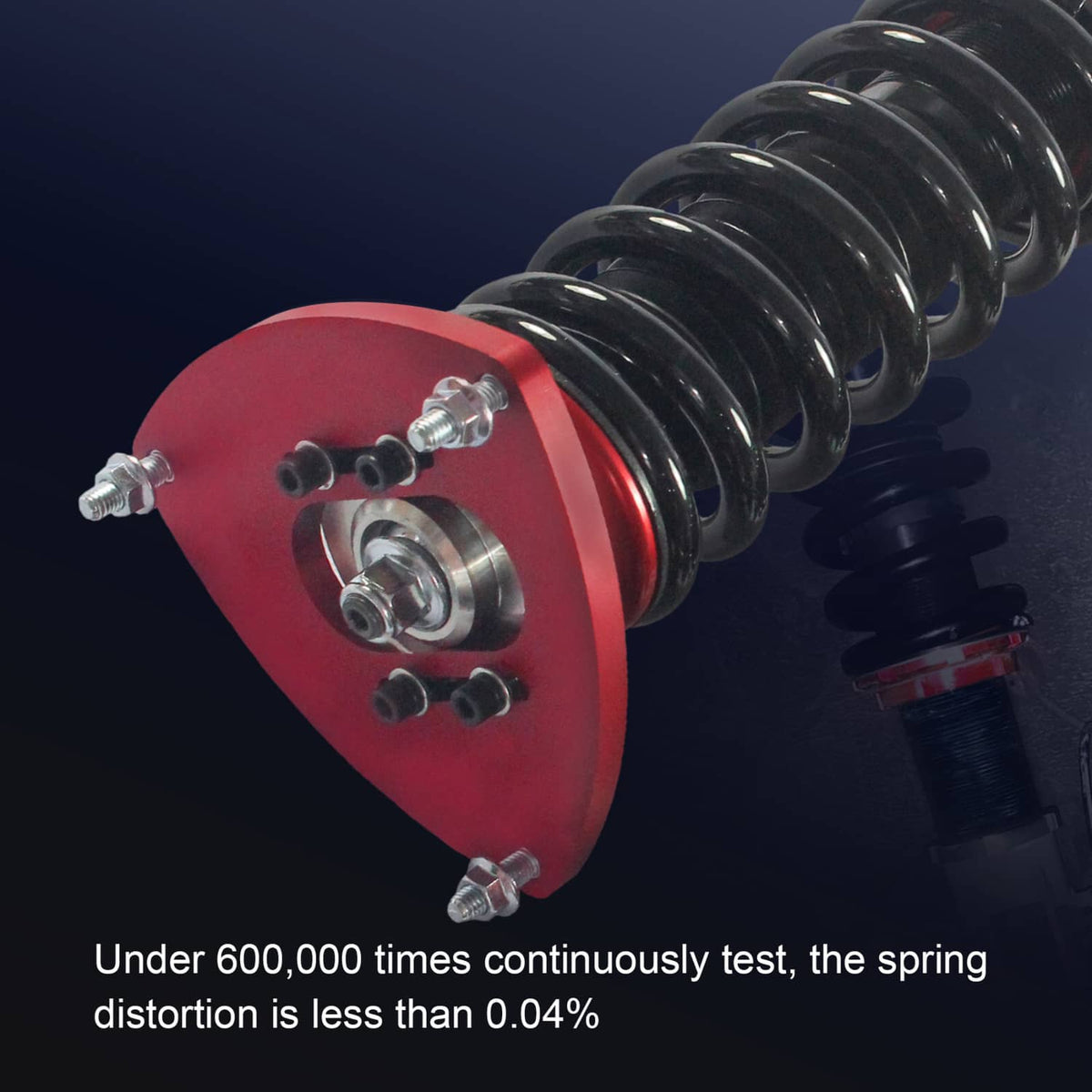 Coilover strut close-up with red spring seat, black spring coils, and mounting studs