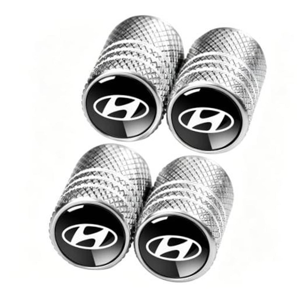 Set of four silver textured tire valve stem dust caps with black Hyundai-style logo face.