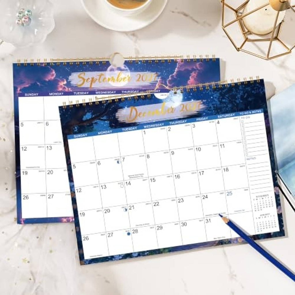 2027 wall calendar set showing September 2027 and December 2027 monthly grids on paper