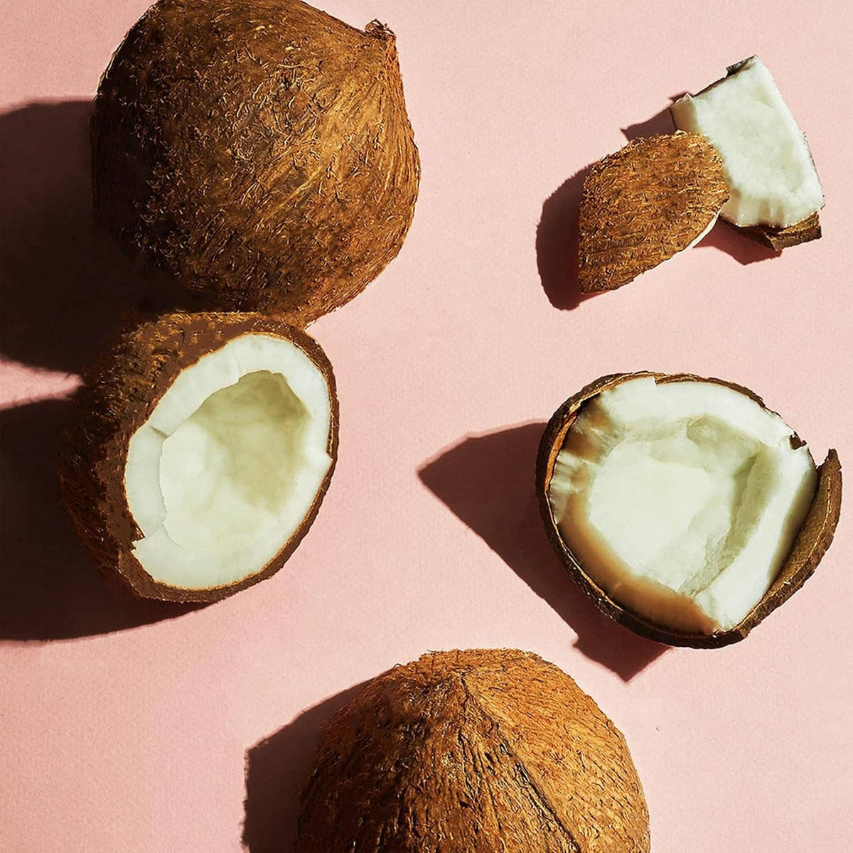 Coconut butter scrub with coconut halves and flakes for exfoliating body care