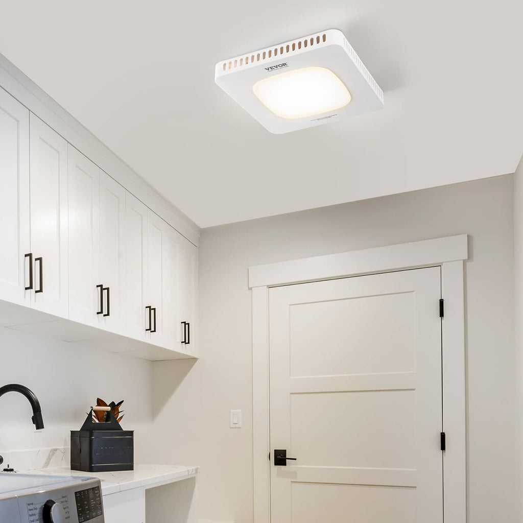 Ceiling-mounted bathroom exhaust fan with LED light emitting a soft warm glow