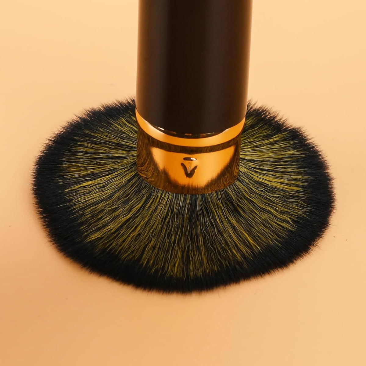 Retractable blusher brush head with dense dark bristles and champagne-gold ring