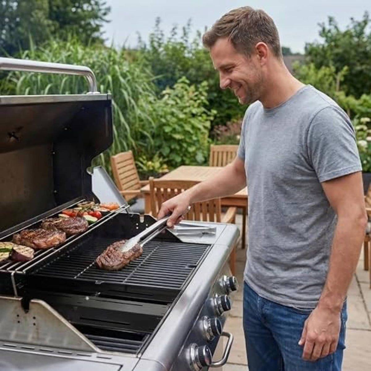 Gas grill with installed universal heat shield plates, dark panels for cooking above burners