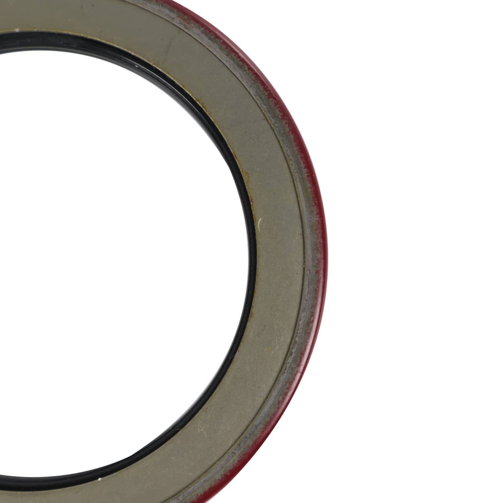 Trailer bearing seal ring close-up with dark metal outer edge and black rubber inner
