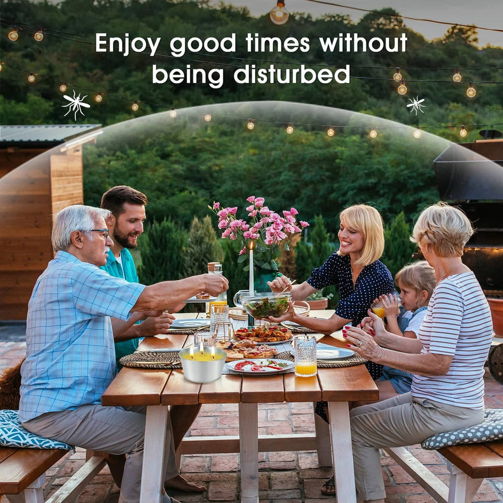 Citronella candles in silver tins with lit wicks on outdoor dining table
