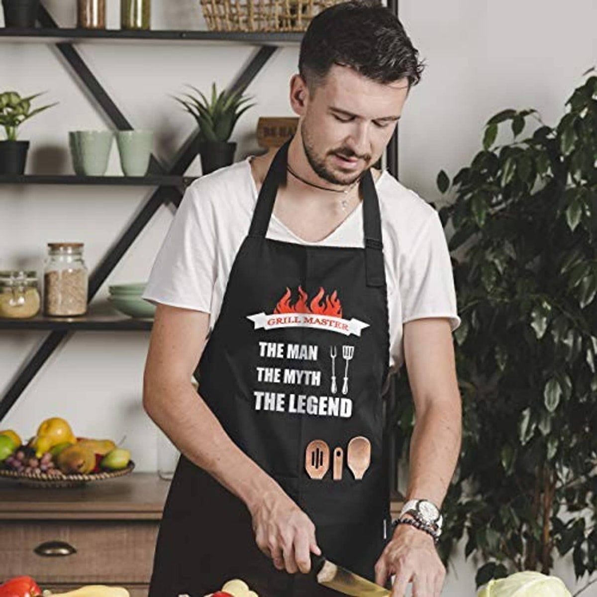Black apron worn by man with flame “Grill Master” chest print and front pocket panel