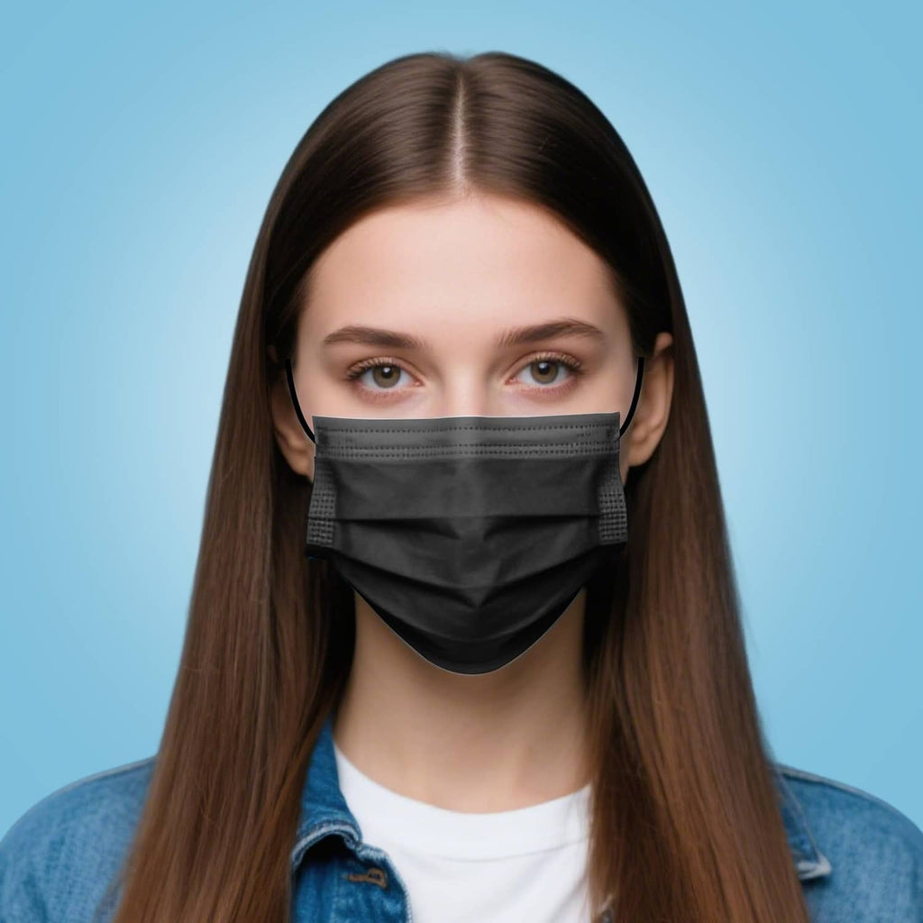 Black disposable face mask on a person with ear loops.