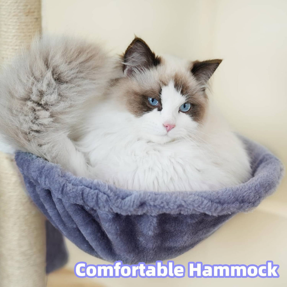 Cat napping in a plush hanging hammock bed on a blue-gray cat tree with sisal post