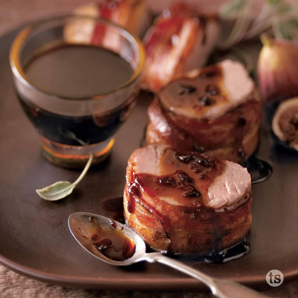 Glazed meat with dark sauce and a small dipping bowl, Bayou Bourbon glaze