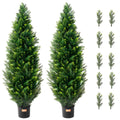 Two artificial cedar topiary trees with bright green leaves in black pots