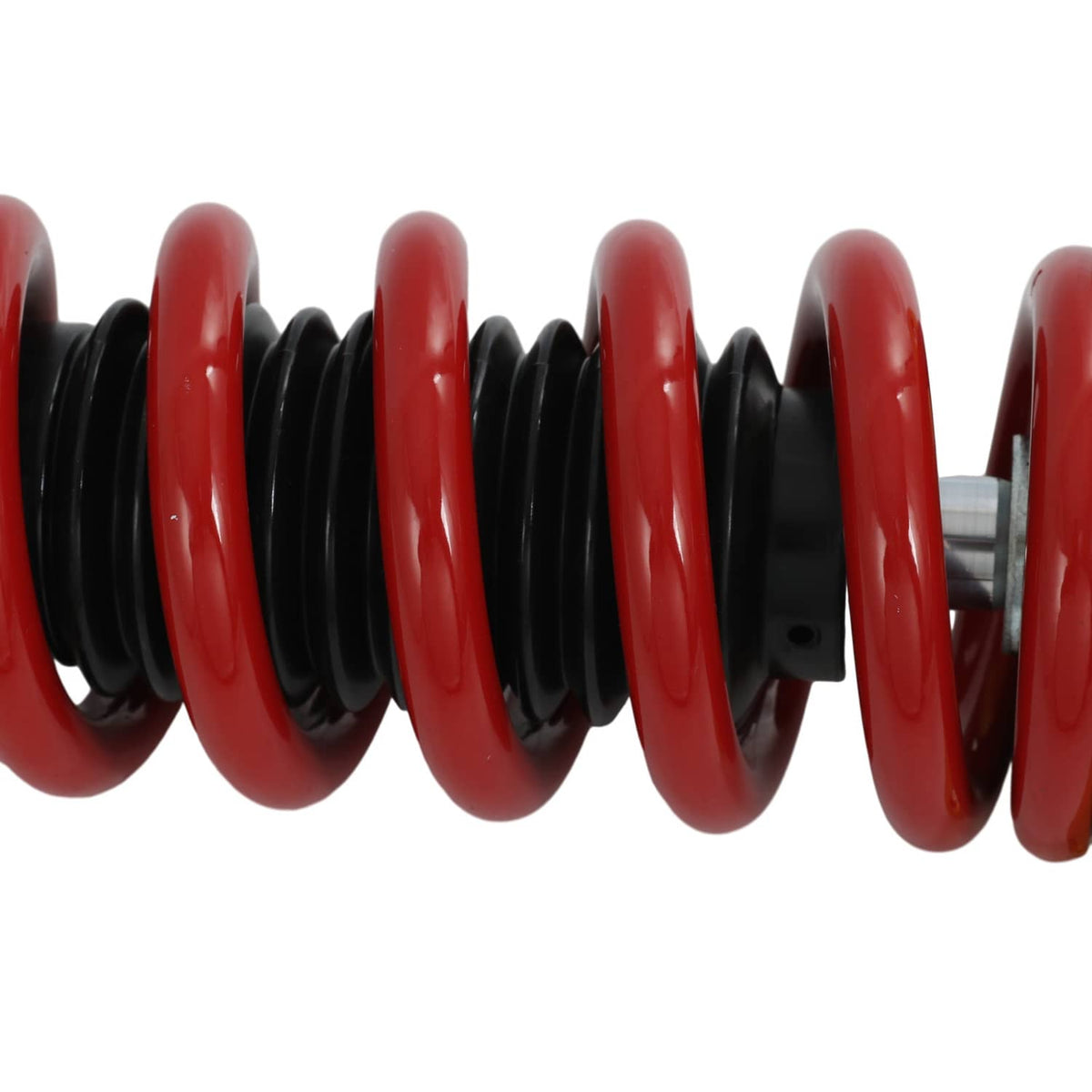 Red coil spring close-up with black isolator sleeves on coilover