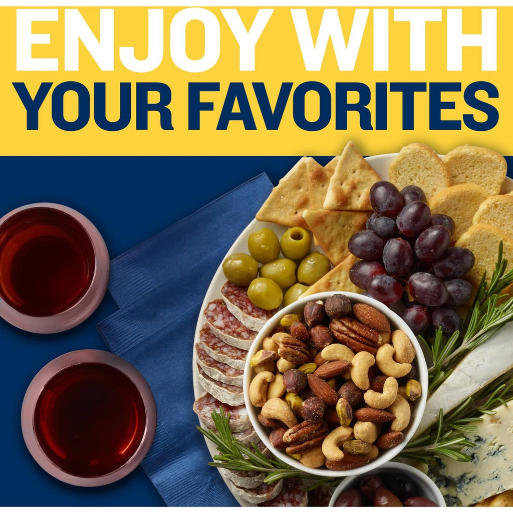 Mixed nuts served with crackers, grapes, and rosemary on a platter