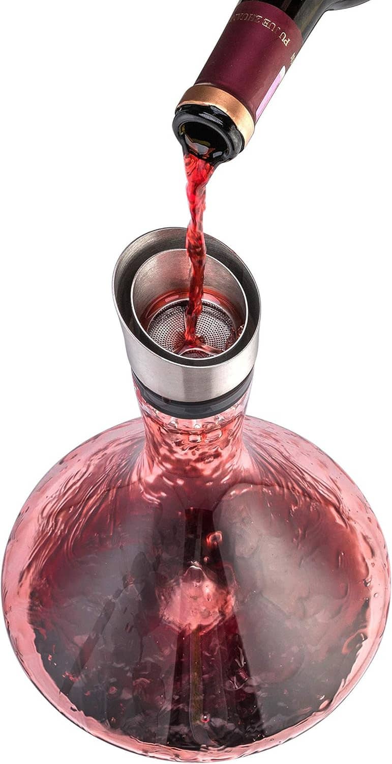 Red wine flowing through the aerator into the decanter cup
