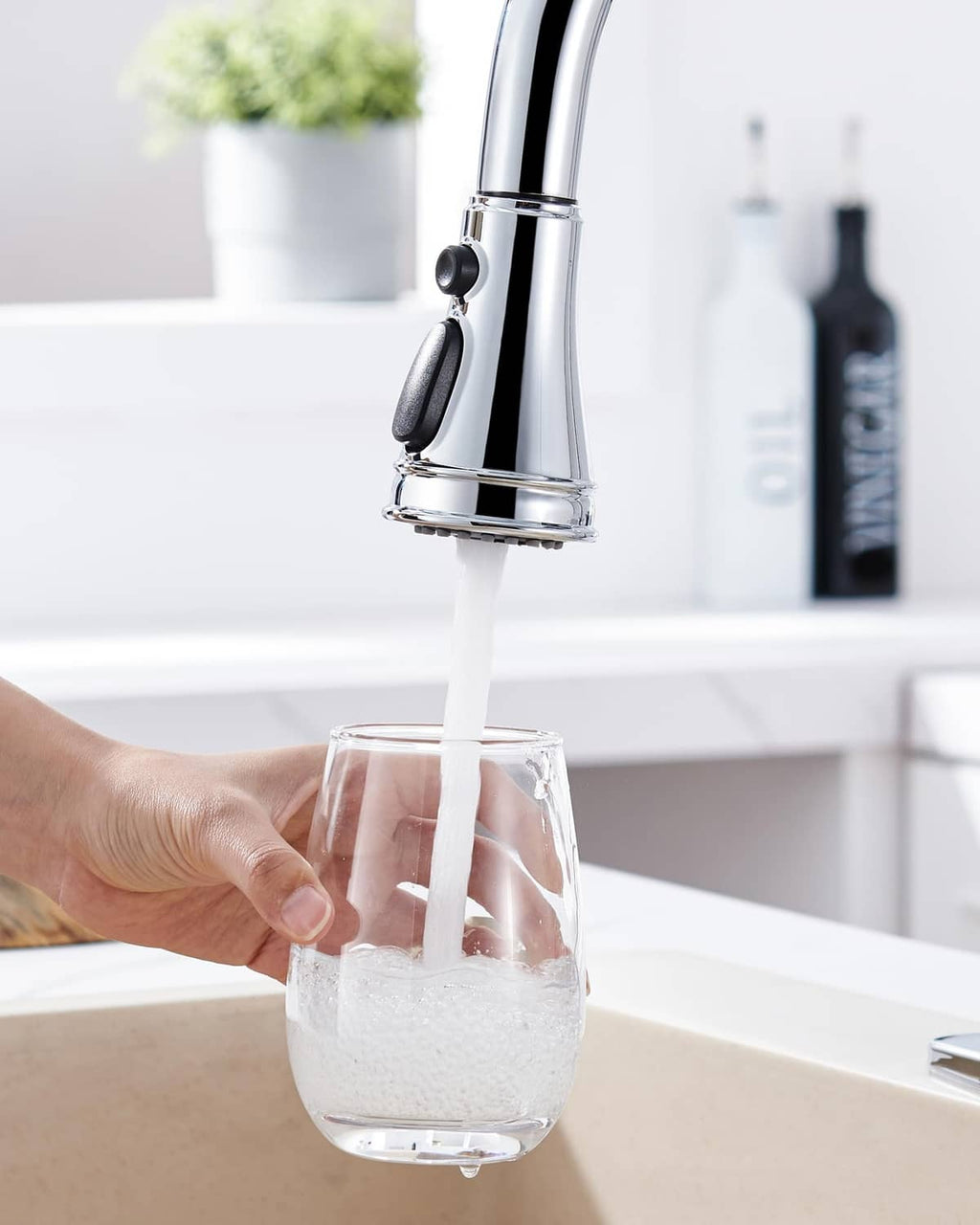 Chrome kitchen faucet spray head replacement producing a steady water stream