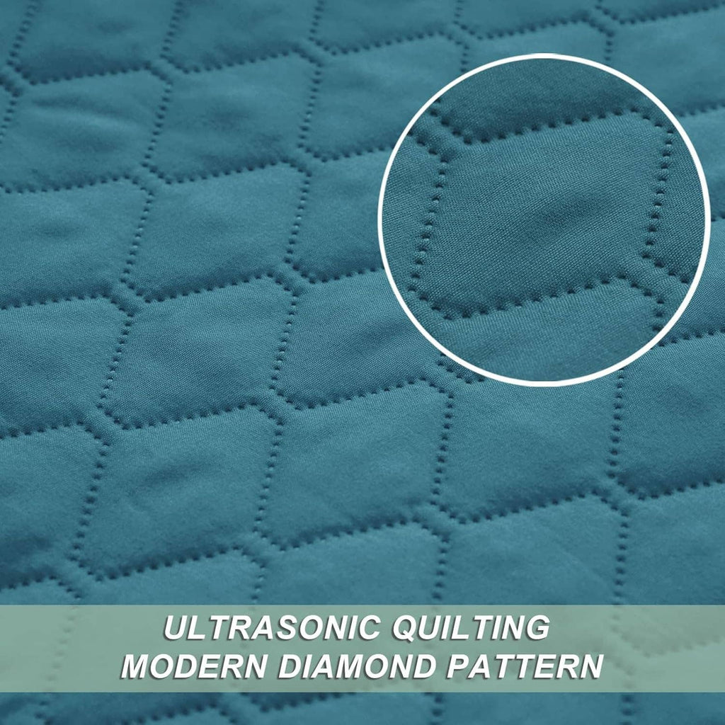 Teal quilt fabric with modern diamond stitching detail, close-up
