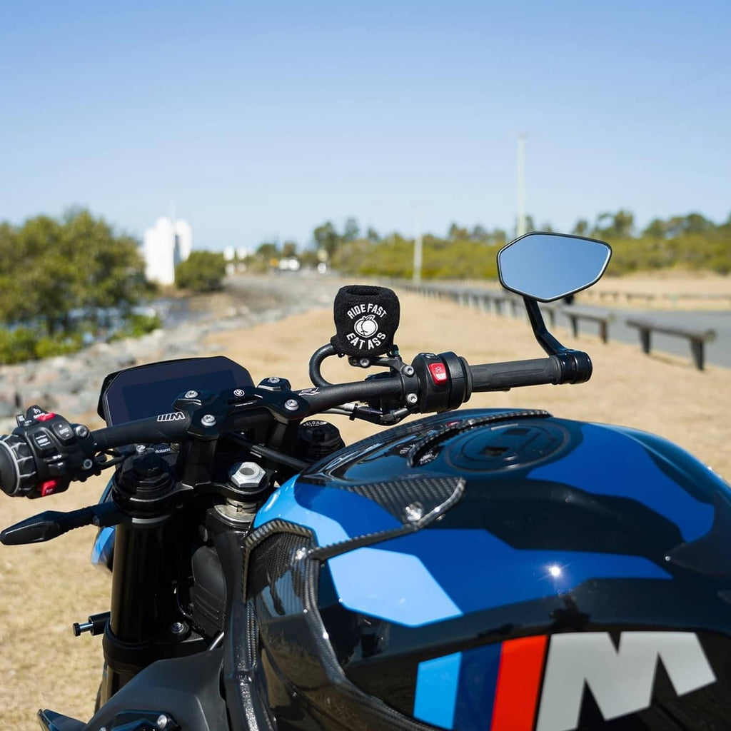 Black brake fluid reservoir cover sock with “RIDE FAST EAT ASS” logo on motorcycle handlebar