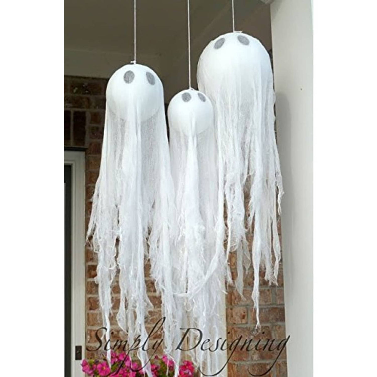 Hanging white paper lanterns with long fringe tails and dome tops