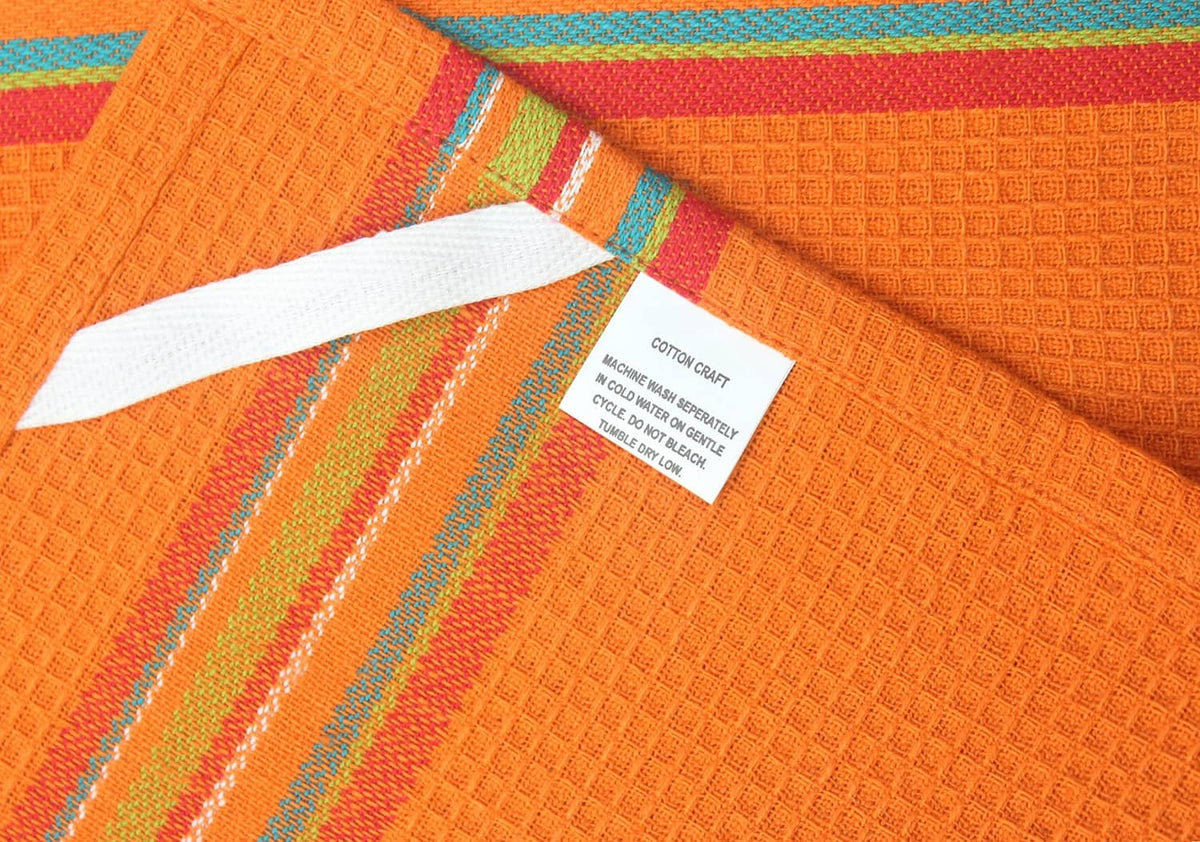 Orange cotton kitchen towel with multicolor salsa stripes and waffle texture