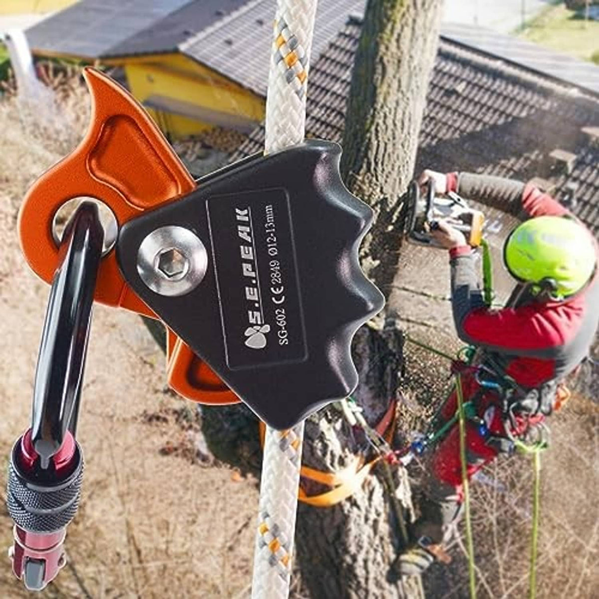 Orange and black rope grab ascender on climbing rope with carabiner attached