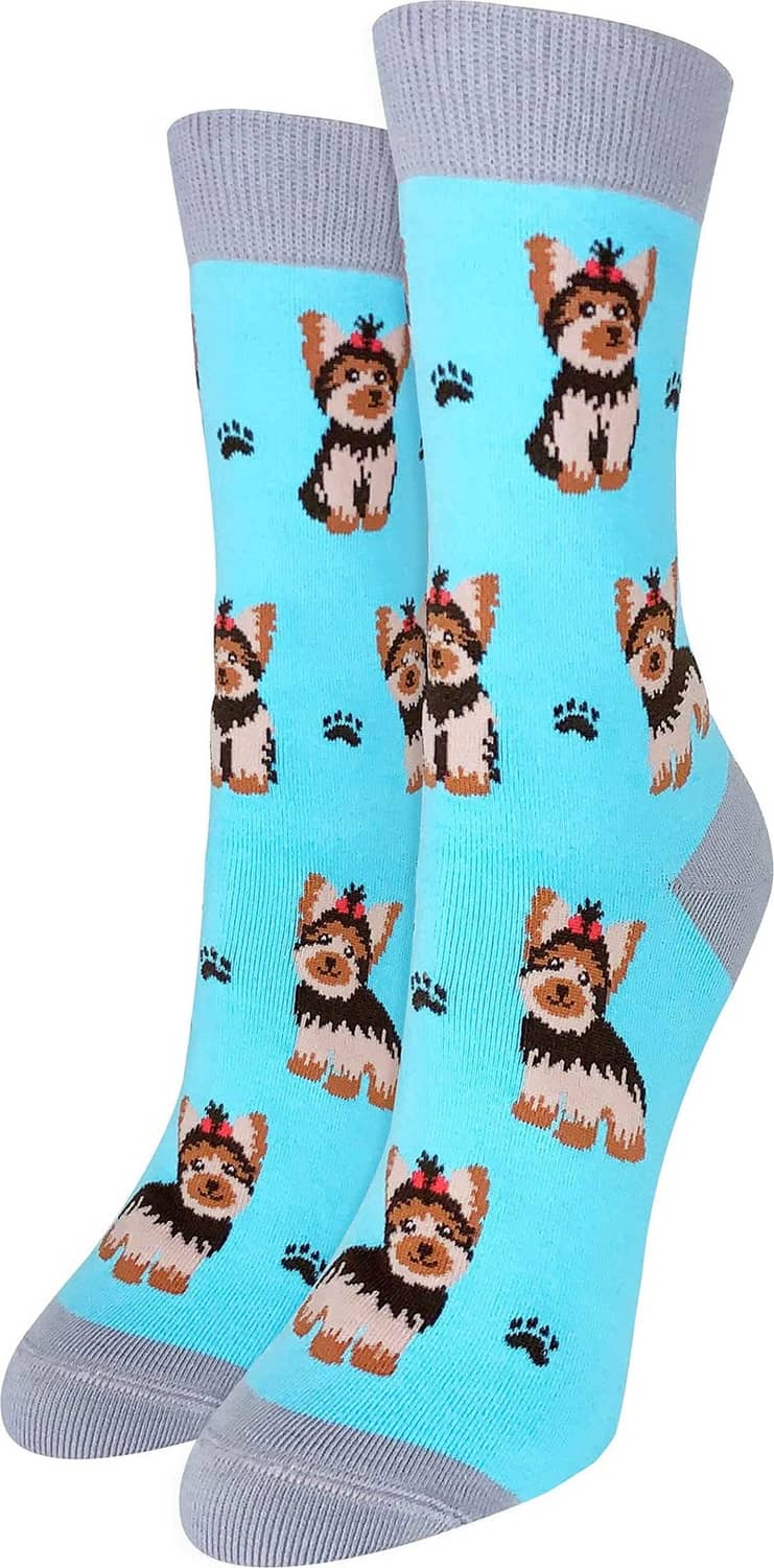 Pair of light blue crew socks with repeating yorkie dog face pattern and paw prints