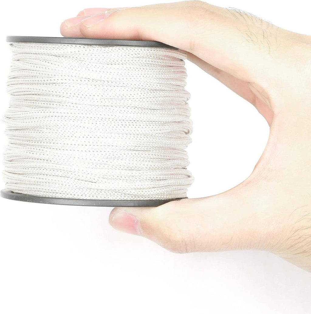 White braided lift shade cord spool held in a hand