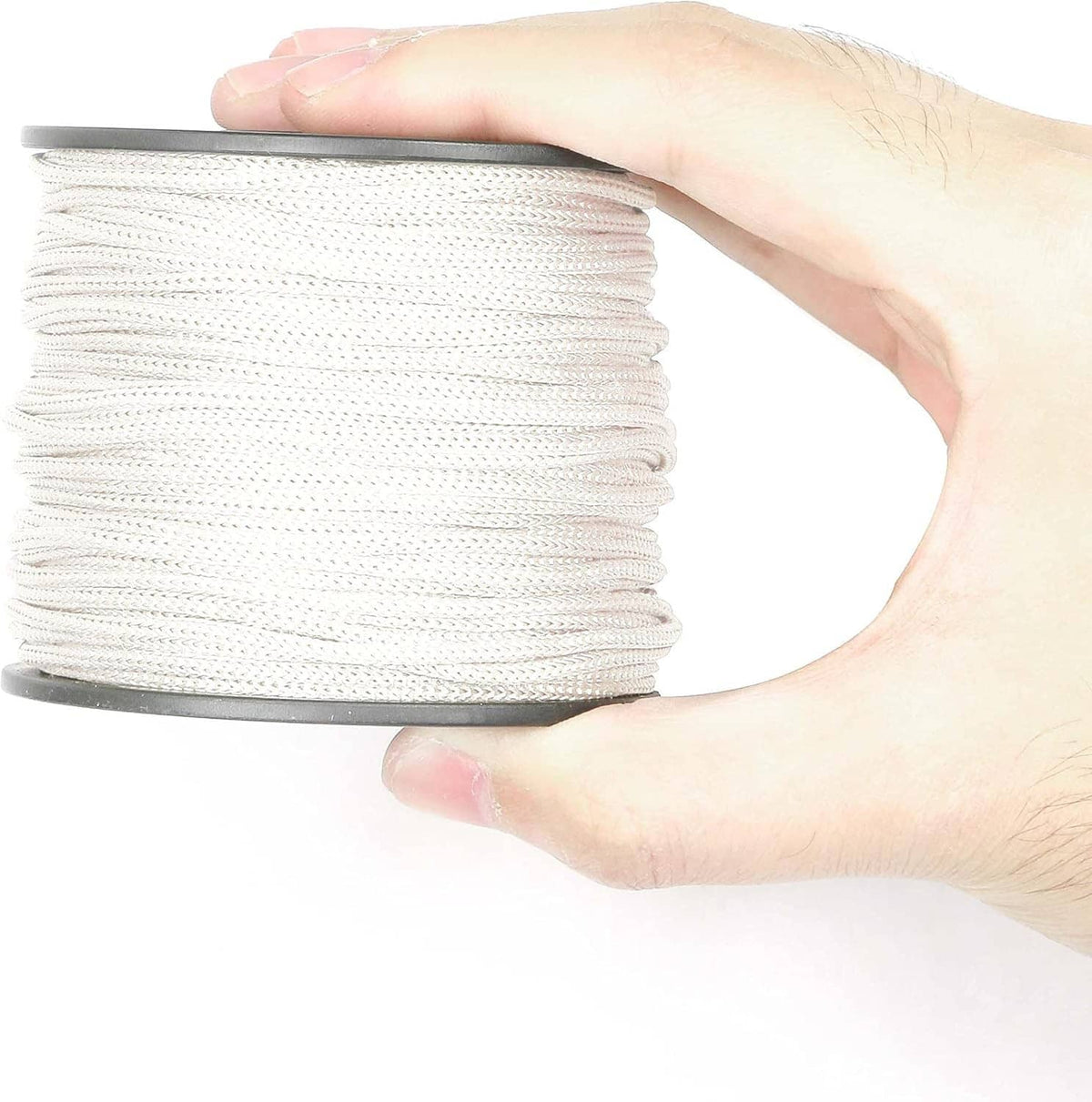 White braided lift shade cord spool held in a hand