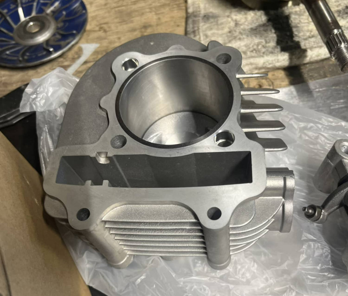 Finned cylinder assembly with smooth bore opening and side ports, shown on clear packaging