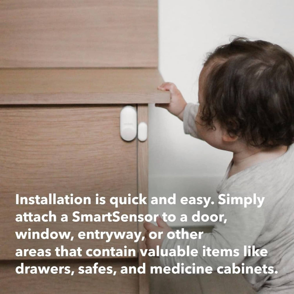 White SmartSensor door/window sensor attached to a wooden door frame
