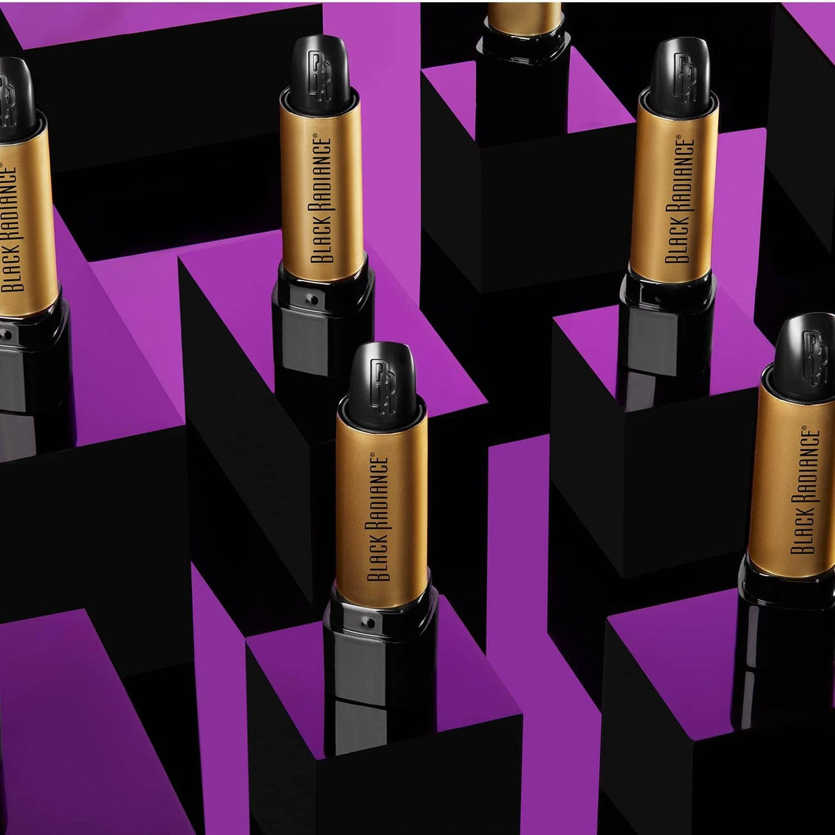 Lipstick assortment display with several black and gold tubes, bullets and cases visible
