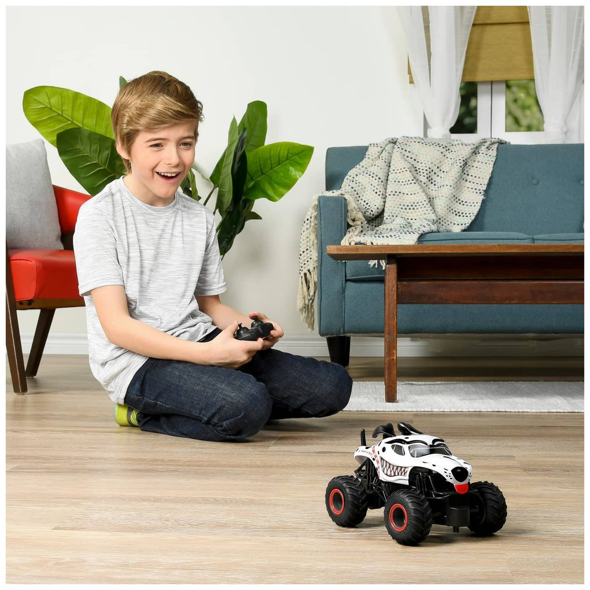 White dalmatian-style RC monster truck toy on the floor
