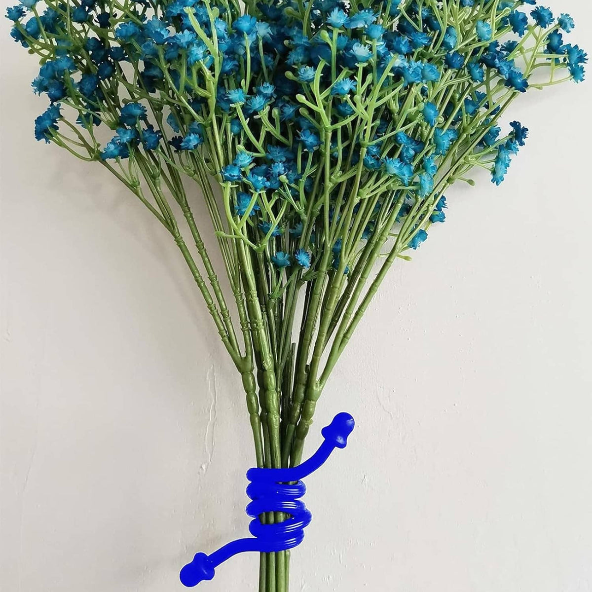Blue silicone twist tie securing a bouquet of blue flowers