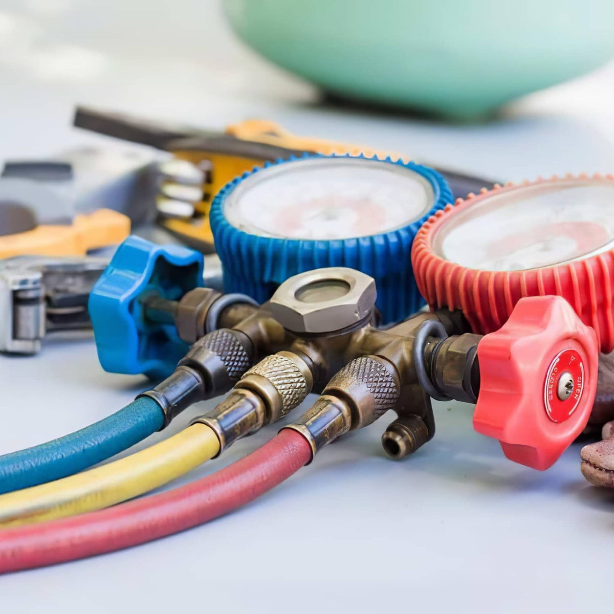 Yellow HVAC charging hose with brass couplers and threaded metal fittings