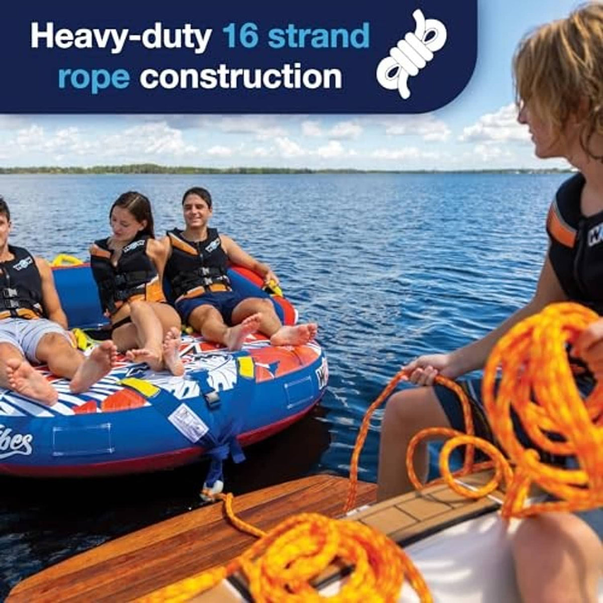 Bright orange tow rope with black foam handle, with riders on an inflatable