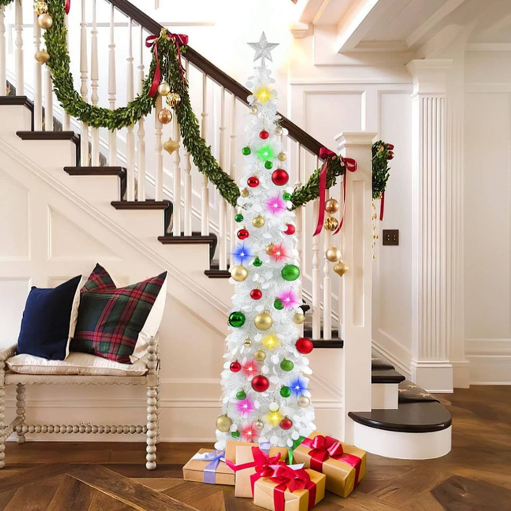 White pop-up Christmas tree with star topper, multicolor lights, and red green gold ornaments