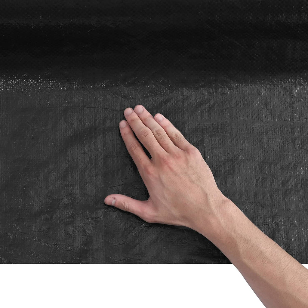 Gray house wrap vapor barrier sheet with hand pressing on textured material