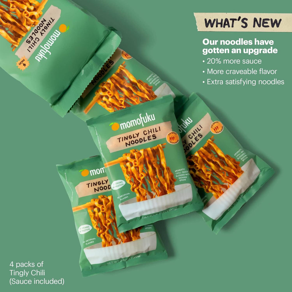 Four tingly chili ramen noodle pouches and sauce sachets arranged for display