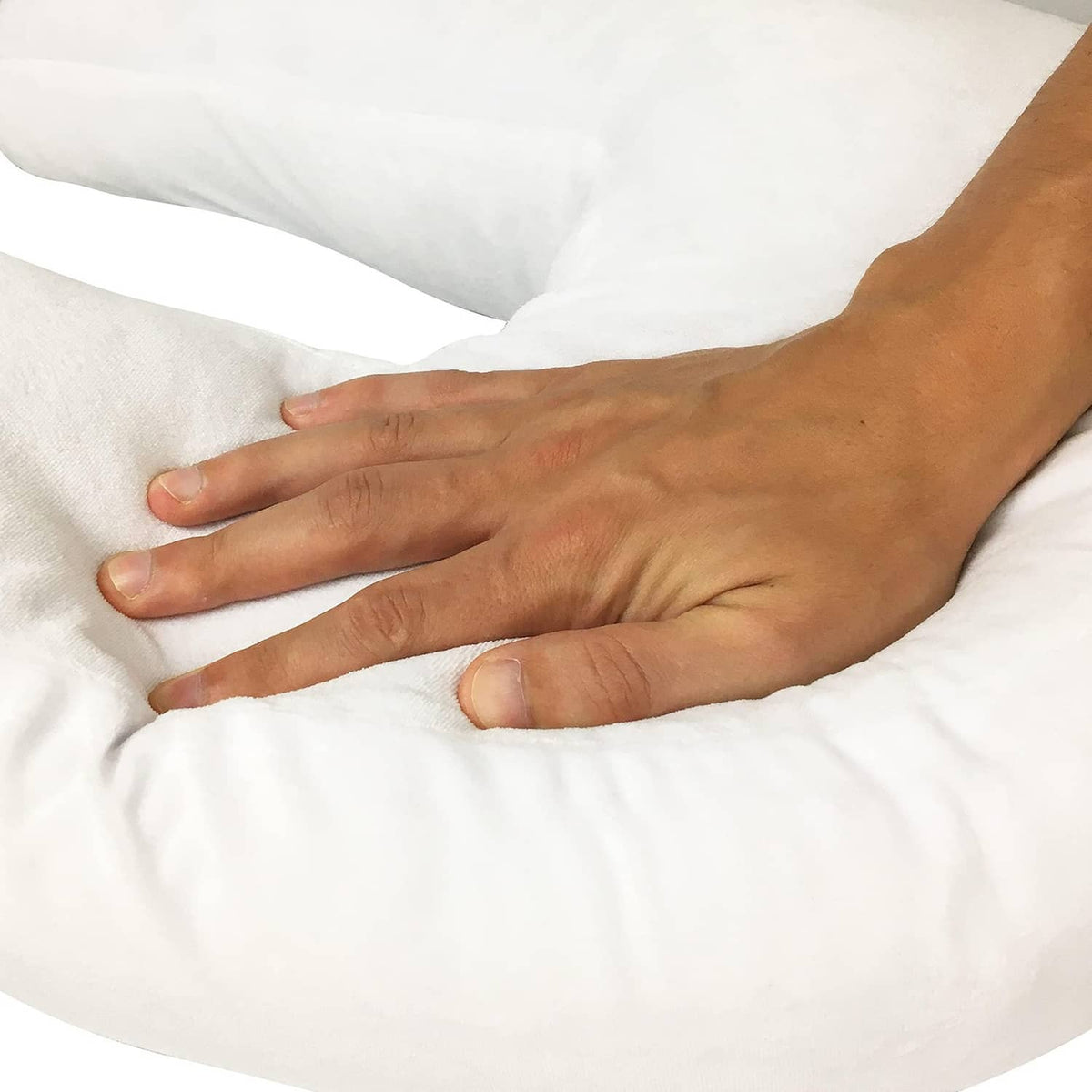 White side sleeper pillow with ear hole, hands smoothing the cover