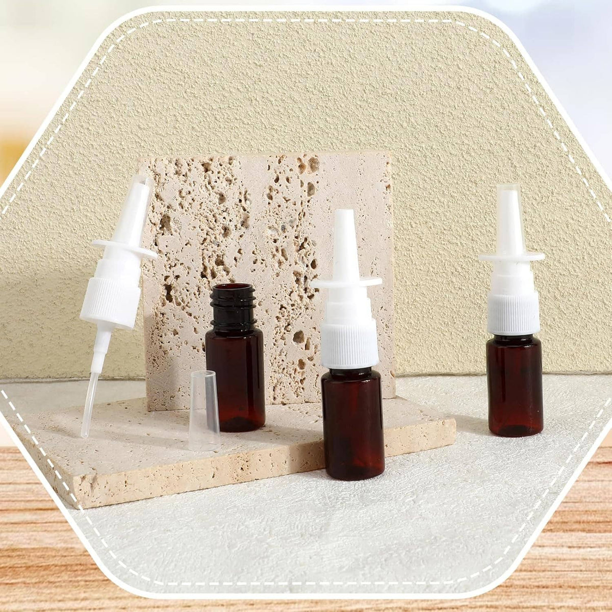 Amber nasal spray bottles with white pumps and clear applicator tips on stand