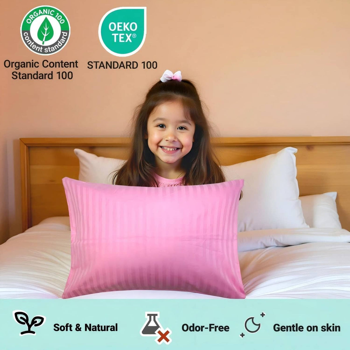 Pink striped toddler pillow on bed, toddler smiling behind