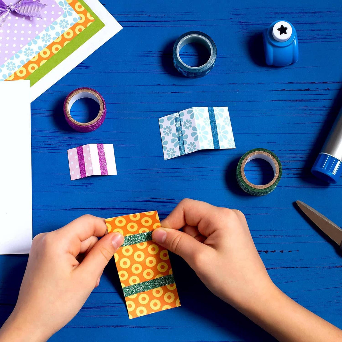 Self-adhesive glitter craft tape roll with small cut pieces for decoration