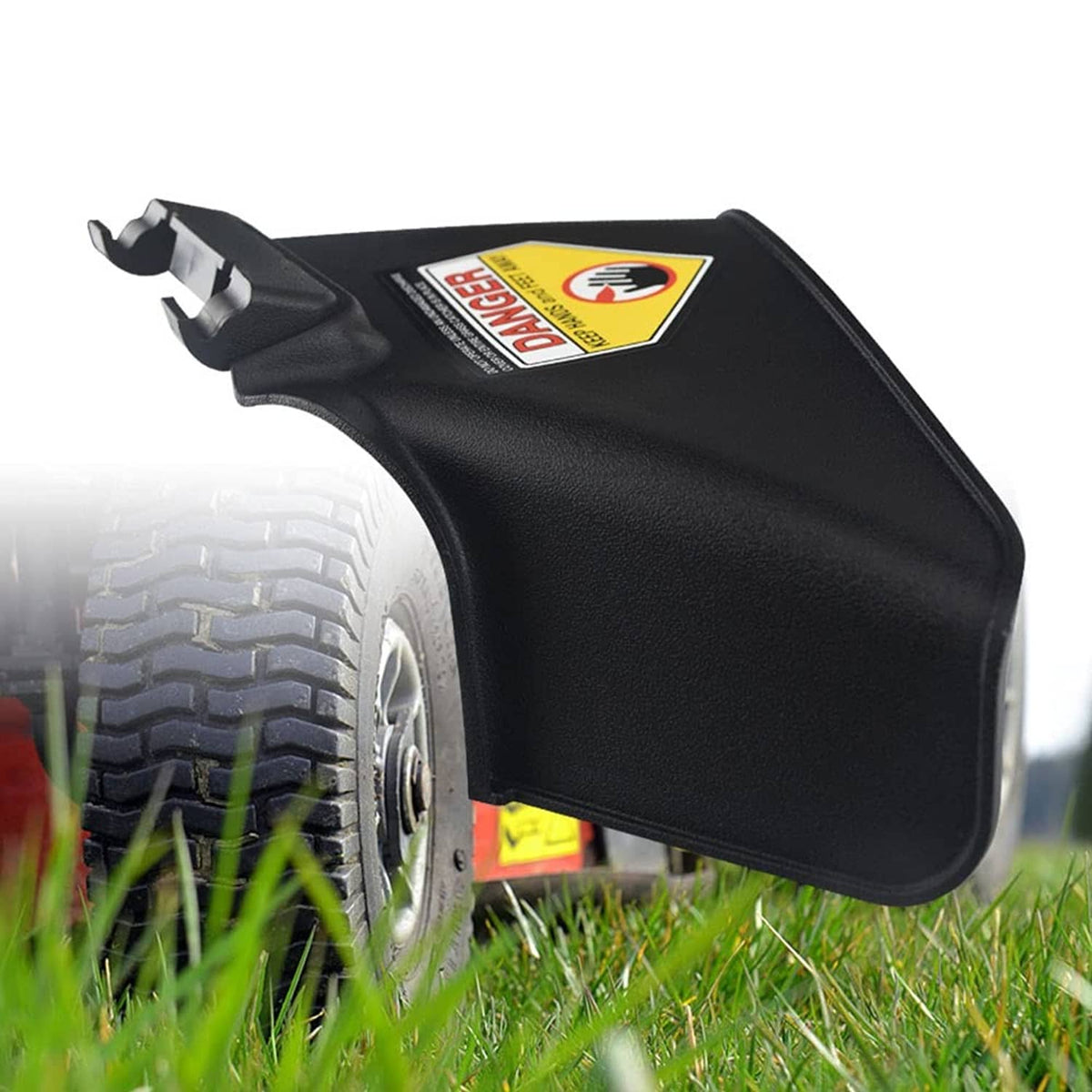 Black side discharge chute close-up with yellow warning label and mounting end tabs