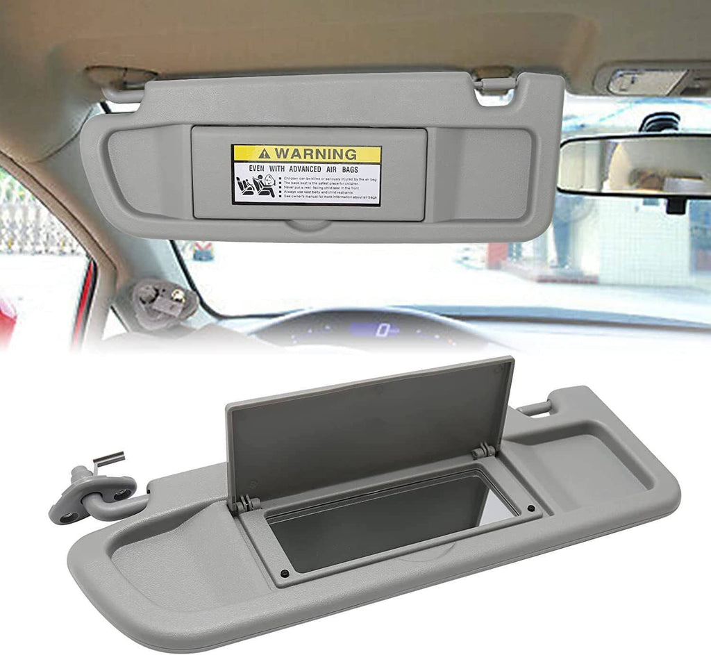 Light gray left driver sun visor with warning label and mounting bracket