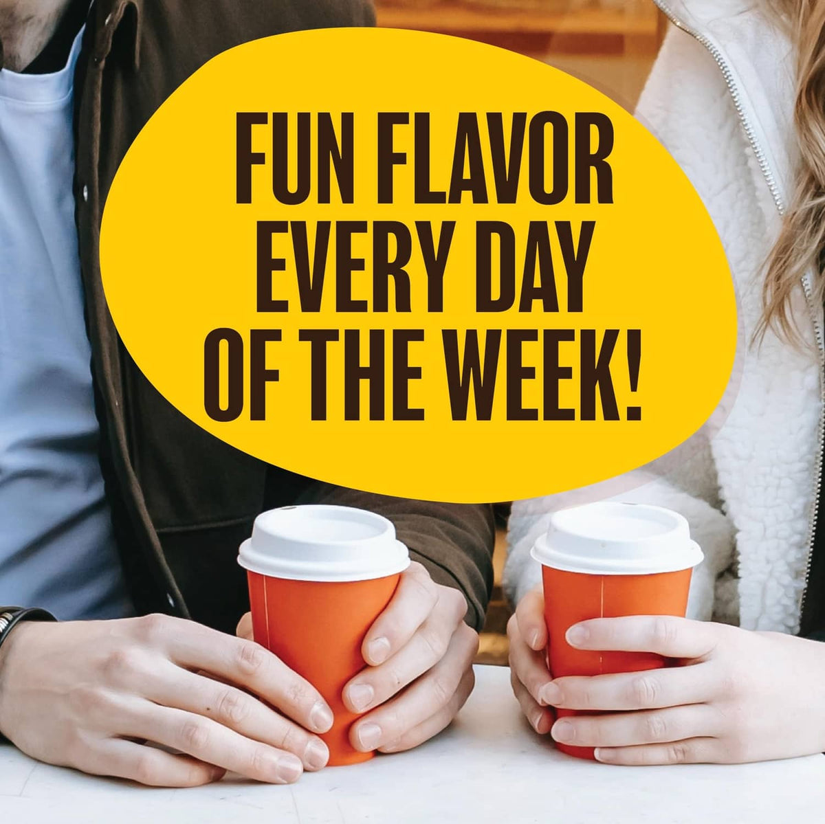 Two people holding takeaway coffee cups under a yellow “Fun flavor” banner
