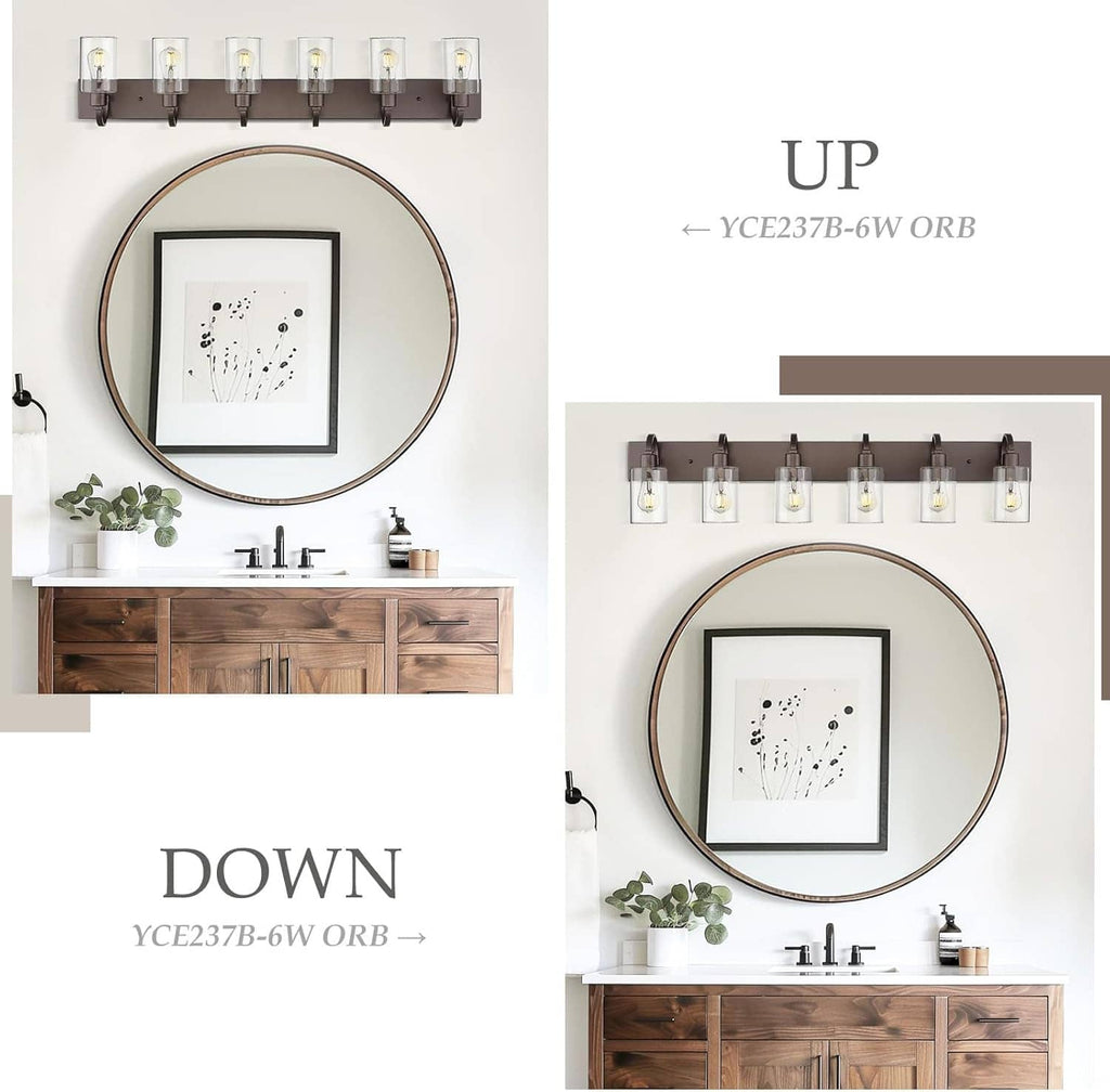 Bathroom vanity light with dark bronze backplate and clear glass cylinder shades