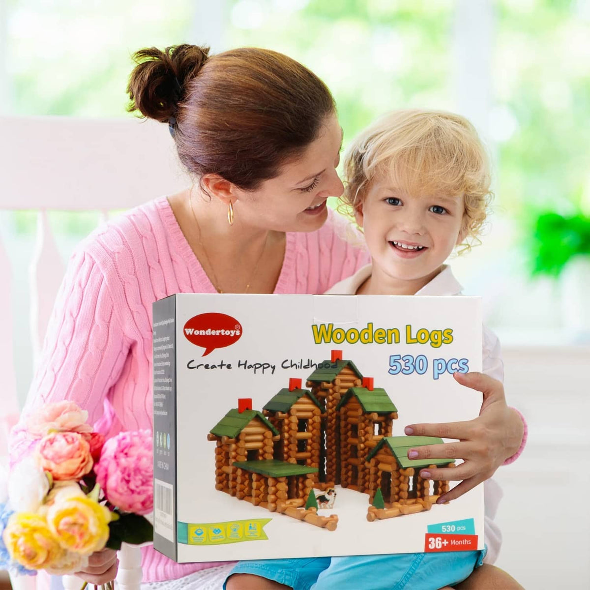 Child holding a wooden log house building set box featuring stacked log homes