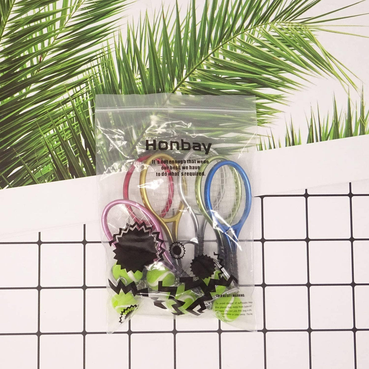 Mini tennis racket keychain set in clear bag with assorted colored rackets and tennis-ball charms