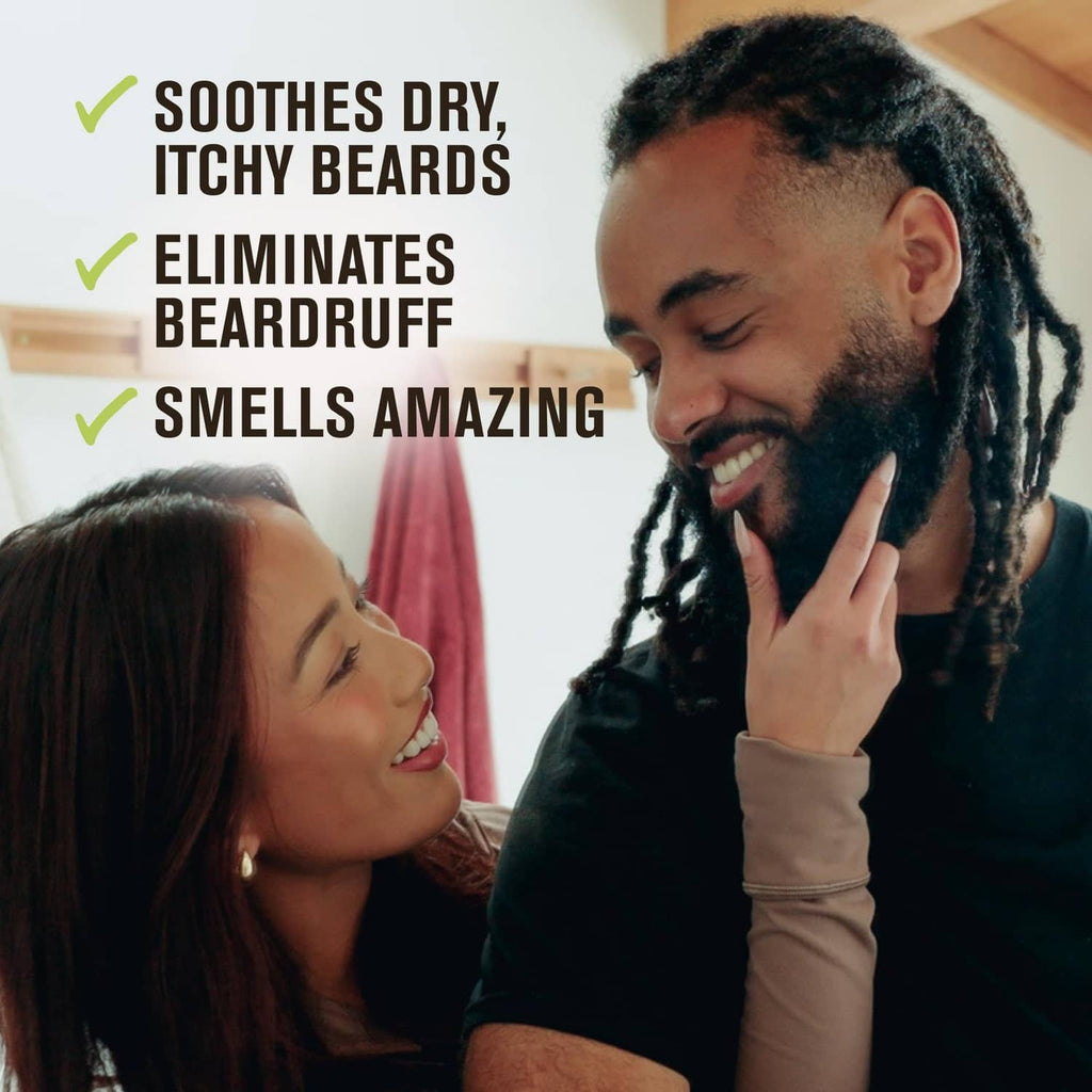 Bearded man applying beard-face lotion to his beard while partner smiles